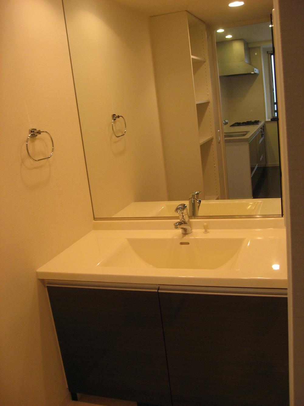 Wash basin, toilet. Wash basin of a large mirror.