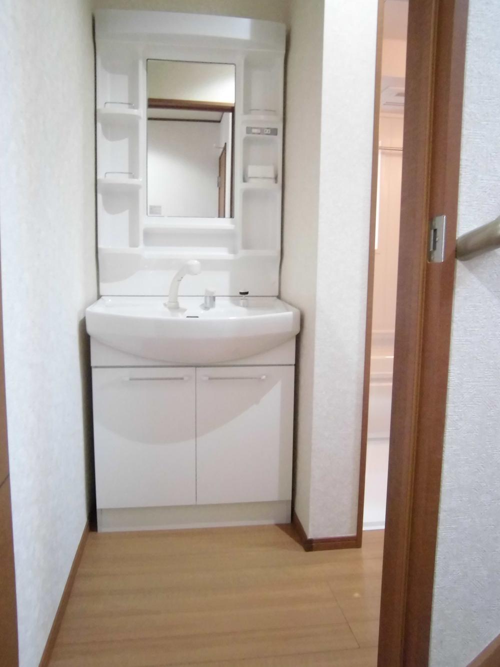 Wash basin, toilet. It is the washroom