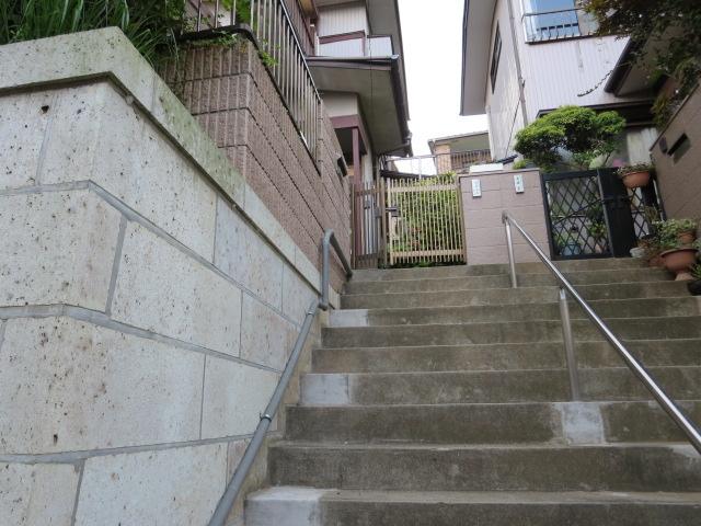 Local appearance photo. Entrance to will continue up the stairs. With handrail.