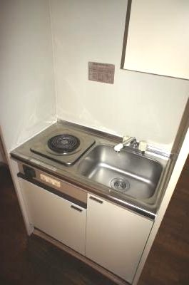 Kitchen. This bite stove and a mini fridge marked with system kitchen.