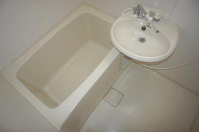 Bath. It is a clean bathroom with wash basin.