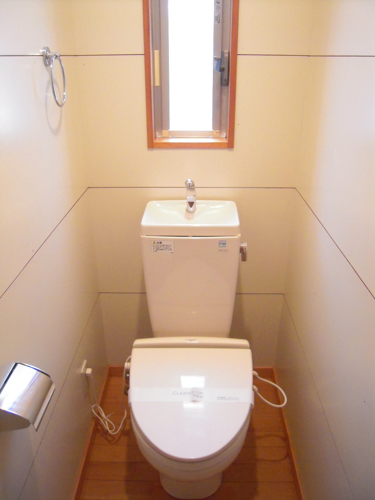 Toilet. It is bright and has a window