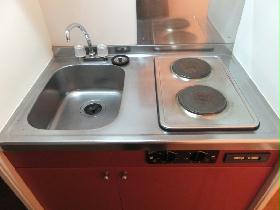 Kitchen. Two-burner electric stove under the sink is storage space