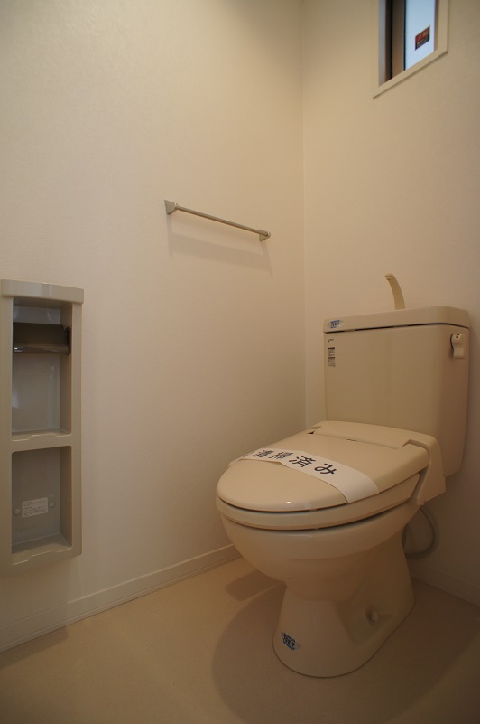 Toilet. Washlet is with the small window