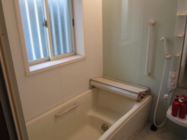 Bathroom. A window with a handrail bathroom