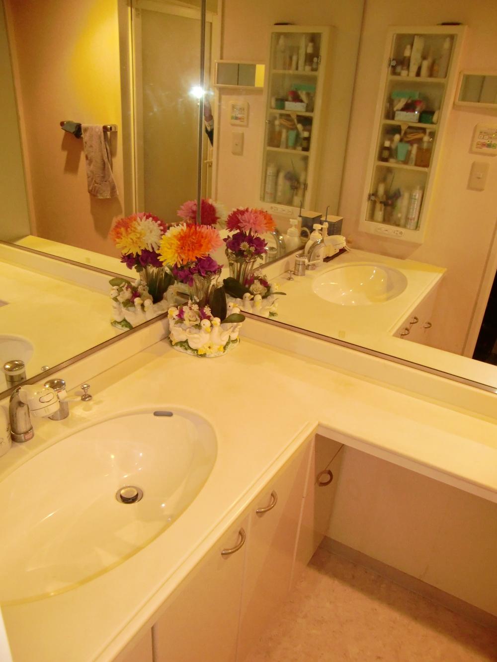 Wash basin, toilet. L-shaped vanity comfortably use with your family