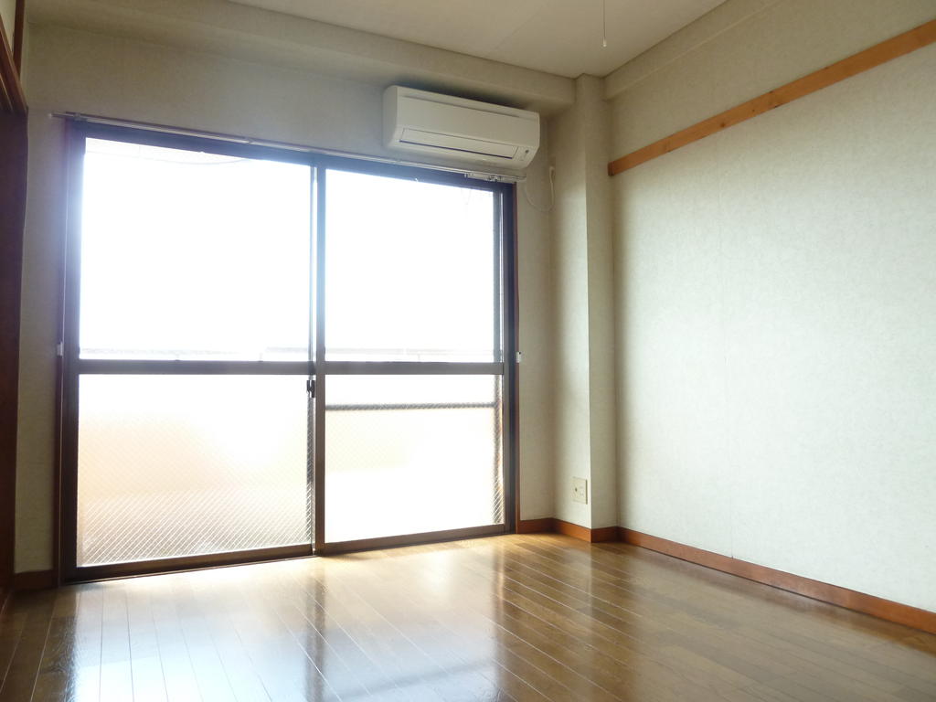 Other room space. Large windows is bright and airy.