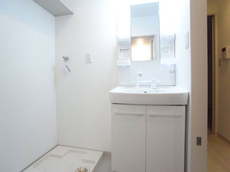 Washroom. Independent wash basin and washing machine inside the room