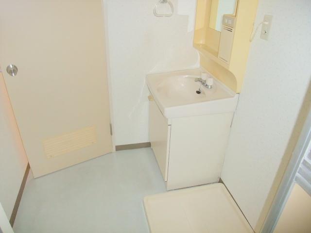 Washroom. Independent sink and washing machine inside the yard