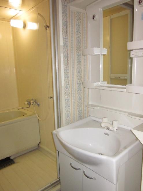 Wash basin, toilet. Unified wash room in bright colors