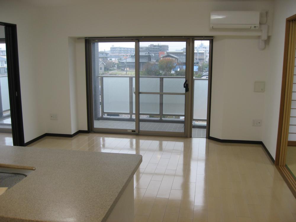 Living. The room overlooks neat because there is no hanging cupboard in the living room the top of from the kitchen.