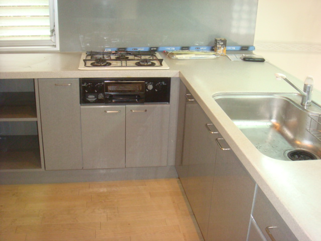 Kitchen. It is L-shaped kitchen reminiscent of overseas.