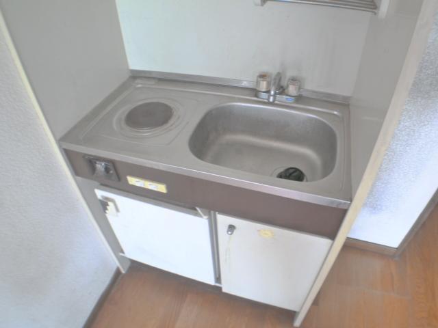 Kitchen. It is a refrigerator and a kitchen that is with electric stove.