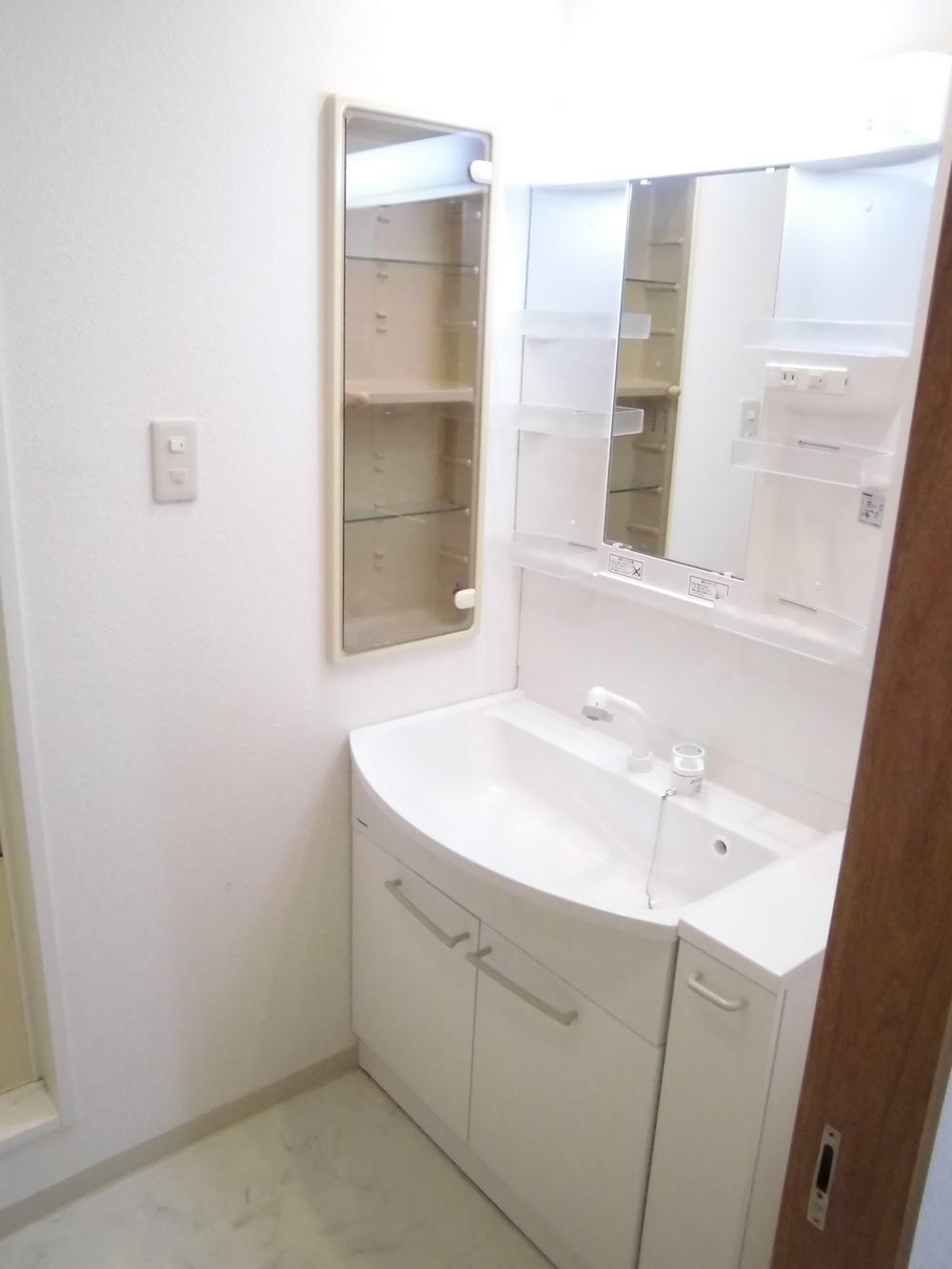 Wash basin, toilet. It is the washroom