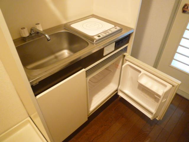 Kitchen. Washing machine storage is also available in the room.