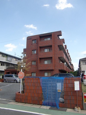 Building appearance. RC apartment of stylish red brick