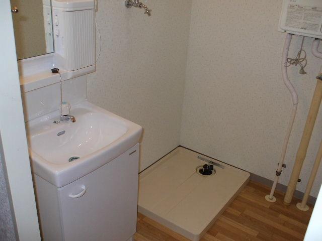 Washroom. Independent sink and washing machine inside the yard