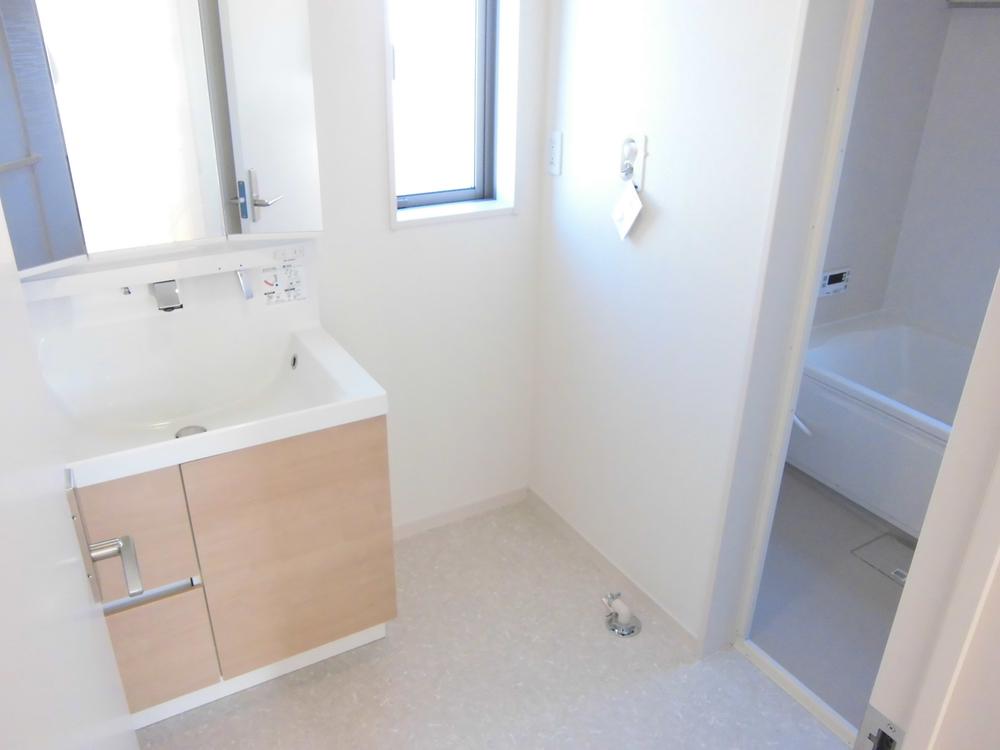 Wash basin, toilet. It is the washroom