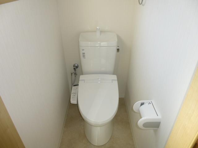 Toilet. There is also a window with a bidet