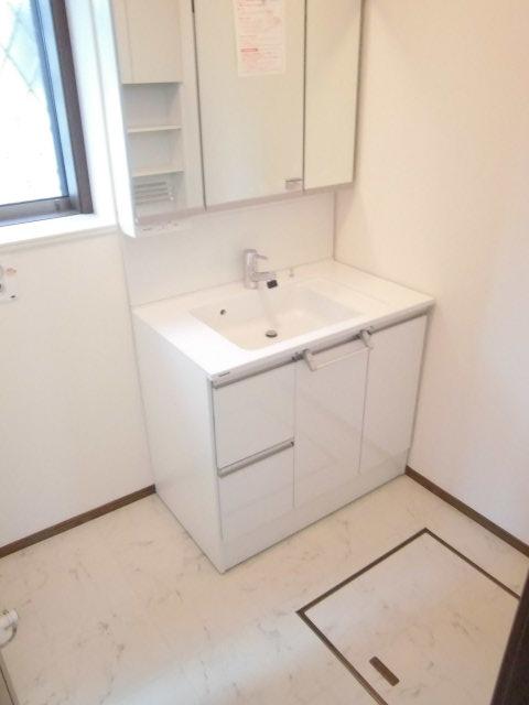 Wash basin, toilet. It is the washroom