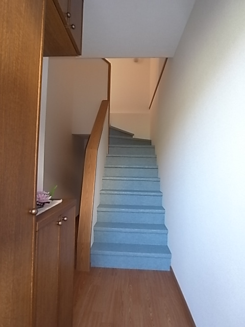 Entrance. From the first floor stairs to the second floor of the residential space. There is storage under the stairs.