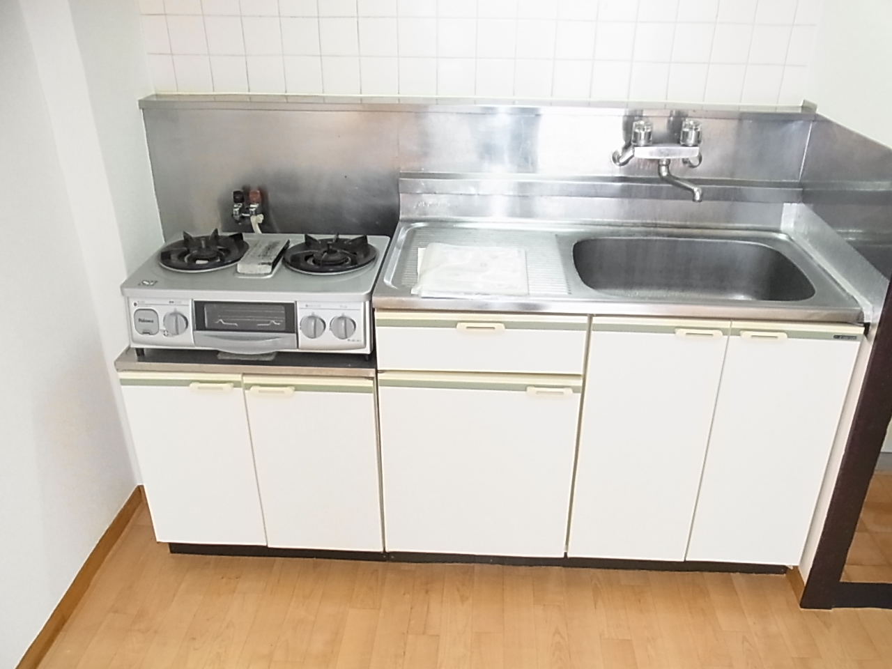 Kitchen. Two-burner stove installed already with happy grill
