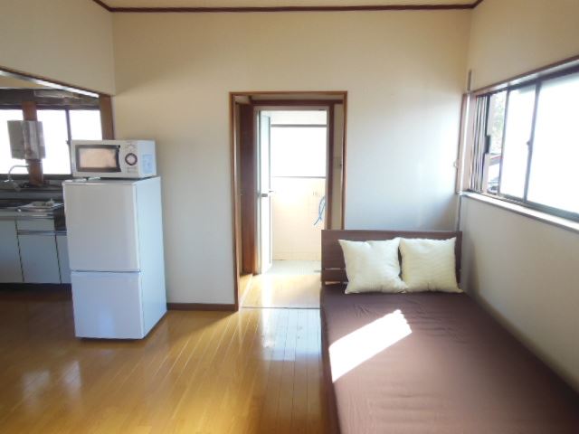 Living and room. 2-door refrigerator, microwave, bed
