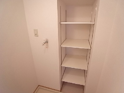 Washroom. There is a shelf in the washroom.