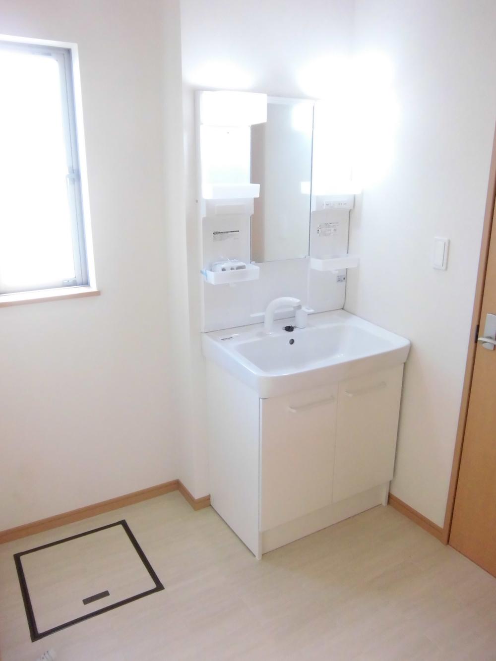 Wash basin, toilet. It is the washroom