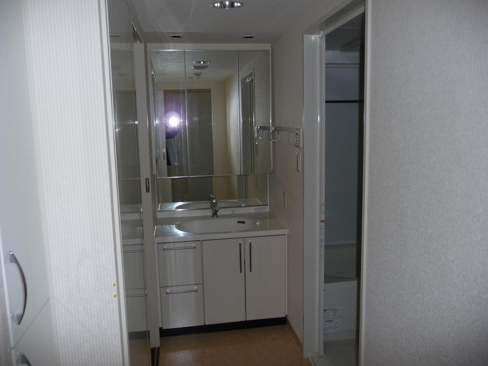 Wash basin, toilet.  ◆ Basin is a vanity with a three-sided mirror.