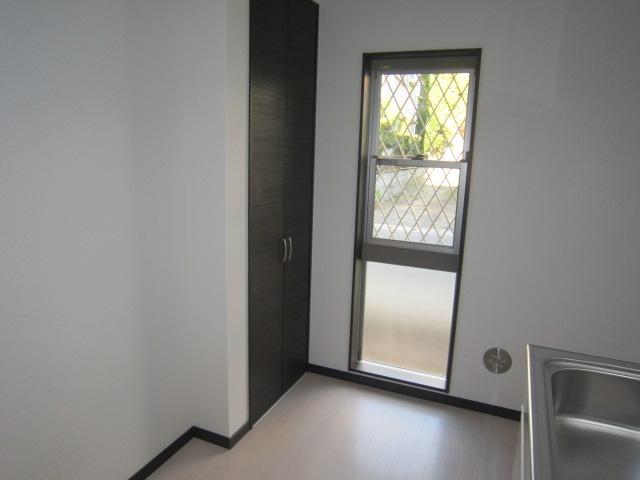 Kitchen. There are also large windows and fixtures of the cupboard in the kitchen.