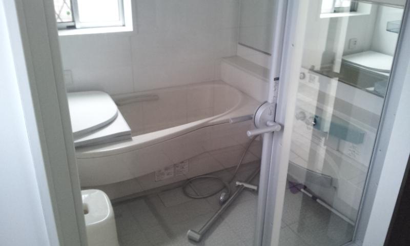 Bathroom. It is a glass-walled bathroom, such as hotels.