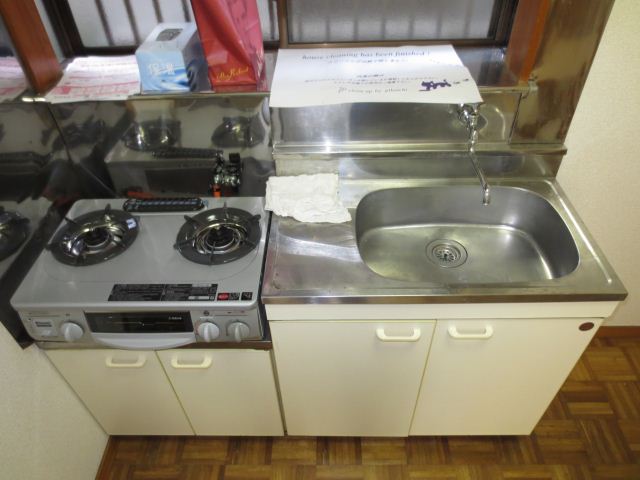 Kitchen. There is a door to the entrance portion and the living room part