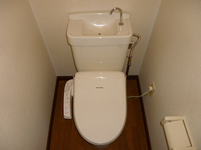 Toilet. A clean toilet white tone With warm water washing toilet seat