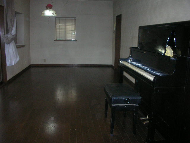 Living and room. Upright piano has left behind