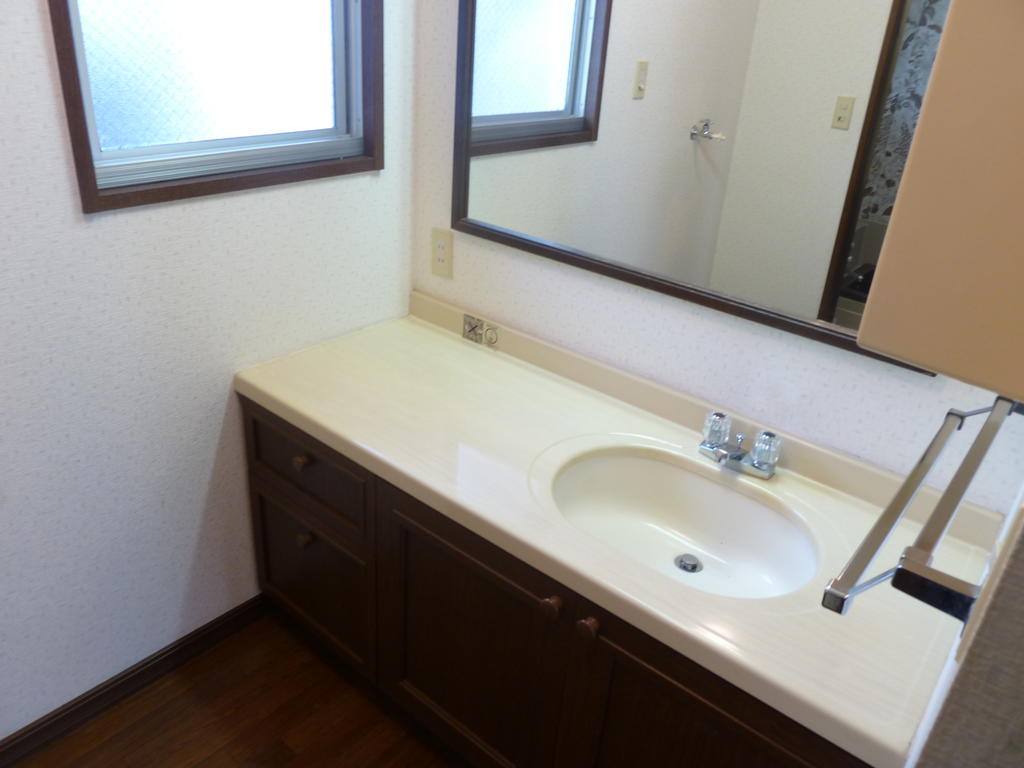 Washroom. Washstand that also includes a wide mirror