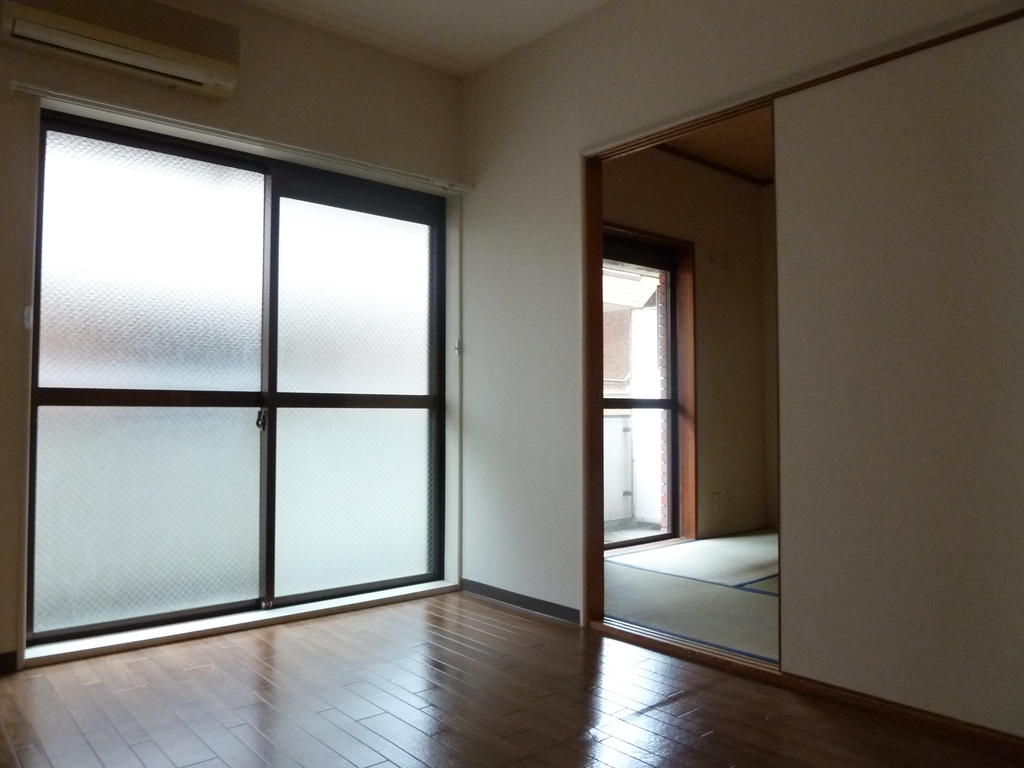 Other room space. Large windows is bright and airy.