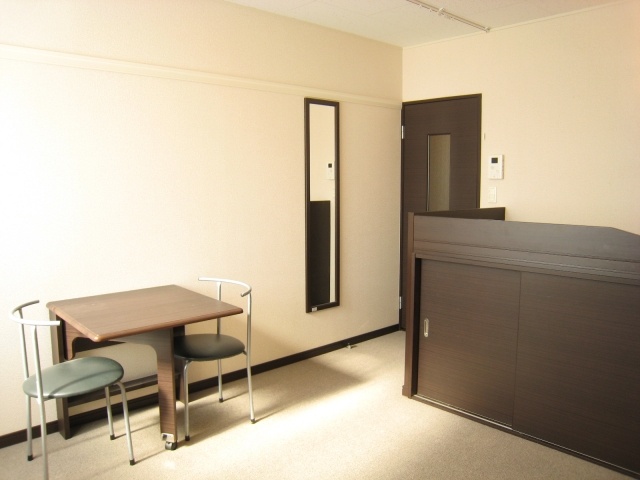 Living and room. Same type of room: two chairs and a folding table is attached.
