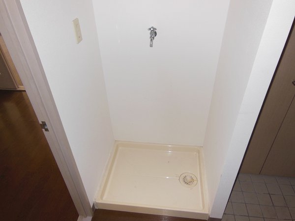 Washroom. Washing machine in the room