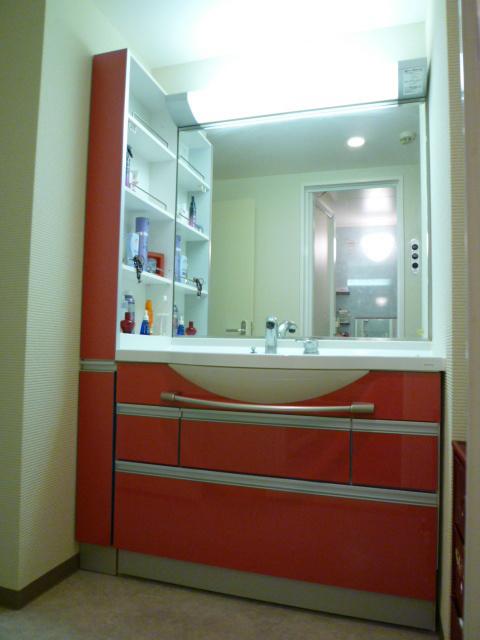 Wash basin, toilet. Characteristic vanity is a large mirror. Shower faucet.