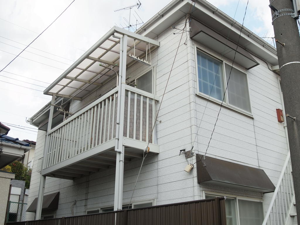 Building appearance. Comfortably Hoseru balcony futon and laundry