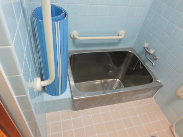 Bathroom. It is a handrail with the bath