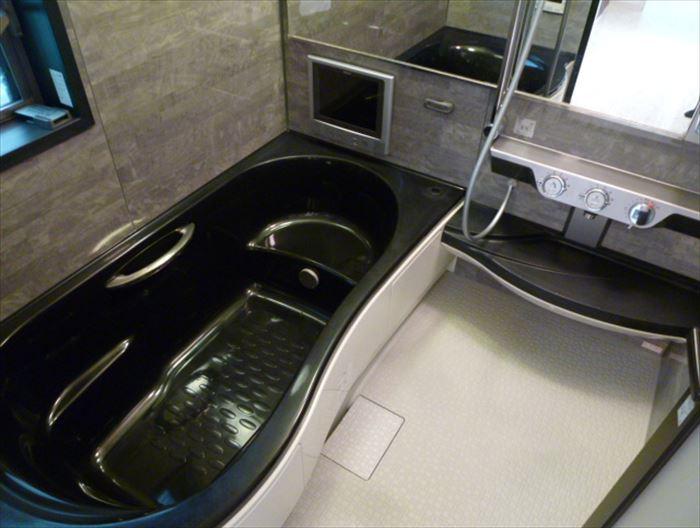 Bathroom. Spacious bath put slowly stretched out foot