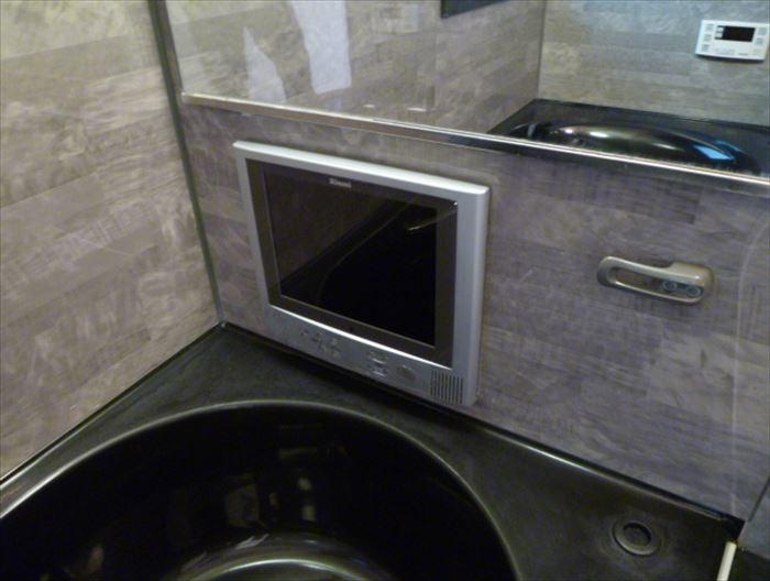 Bathroom. Comfortable bath time dated bathroom TV
