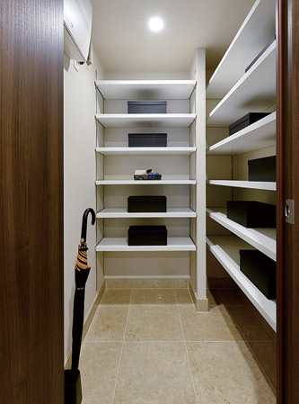 Interior.  [Shoes-in closet] The whole family of shoes and boots, Shoes-in closet that can be organized and umbrella.