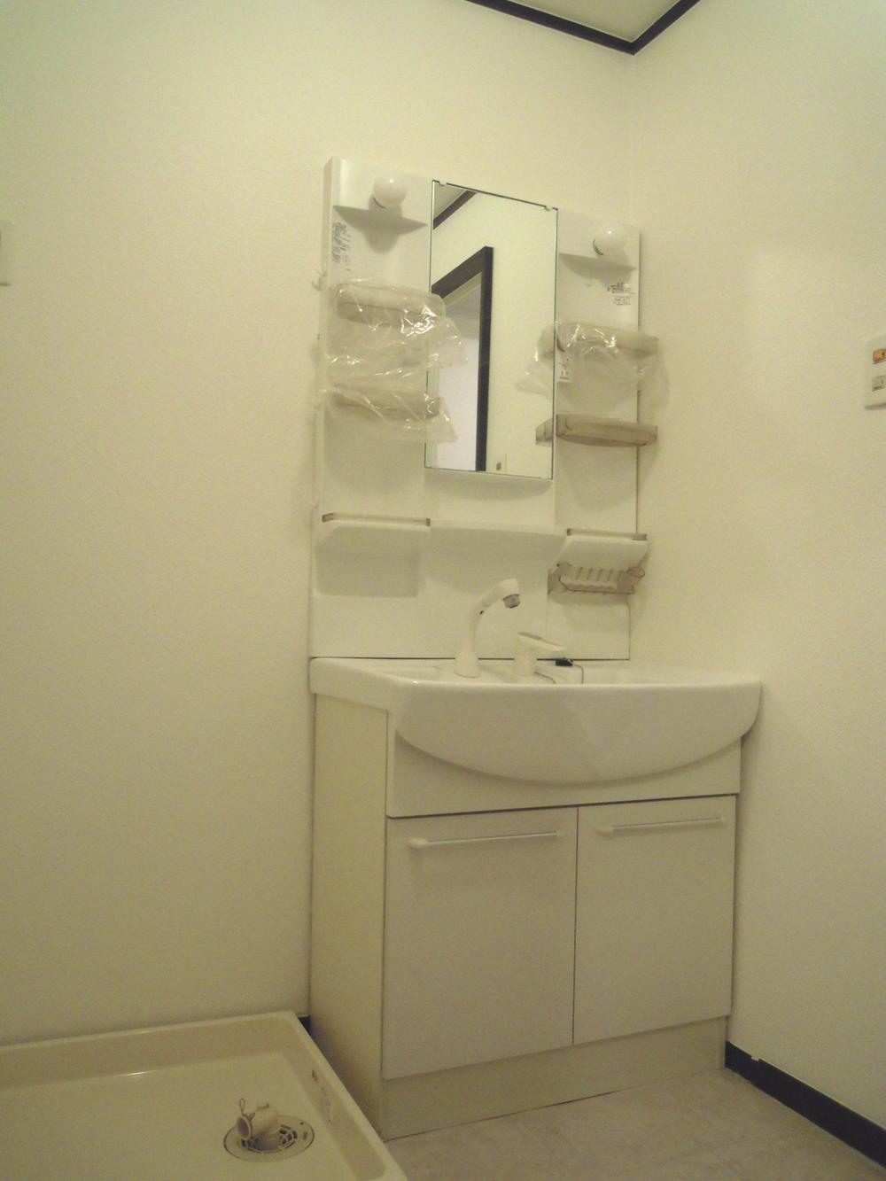 Wash basin, toilet. It is simple and modern washroom in which the white tones.