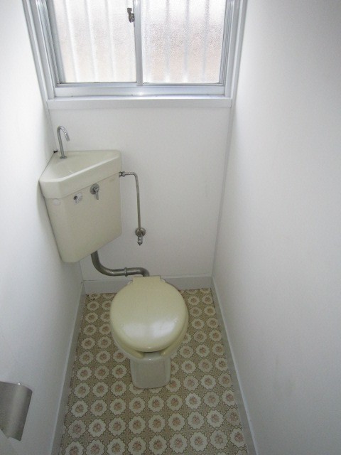 Toilet. There is a window in the toilet. 