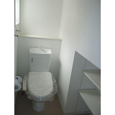 Toilet. The toilet also has a shelf!