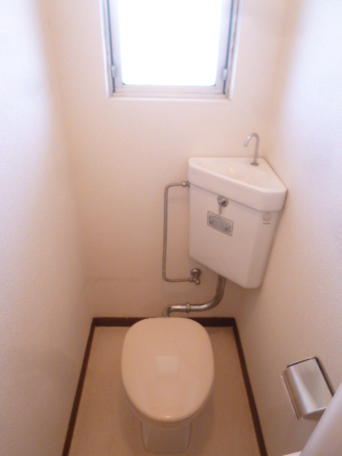 Toilet. It is bright and there is a window