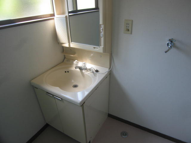Washroom. There lavatory washing machine inside the area of the window there